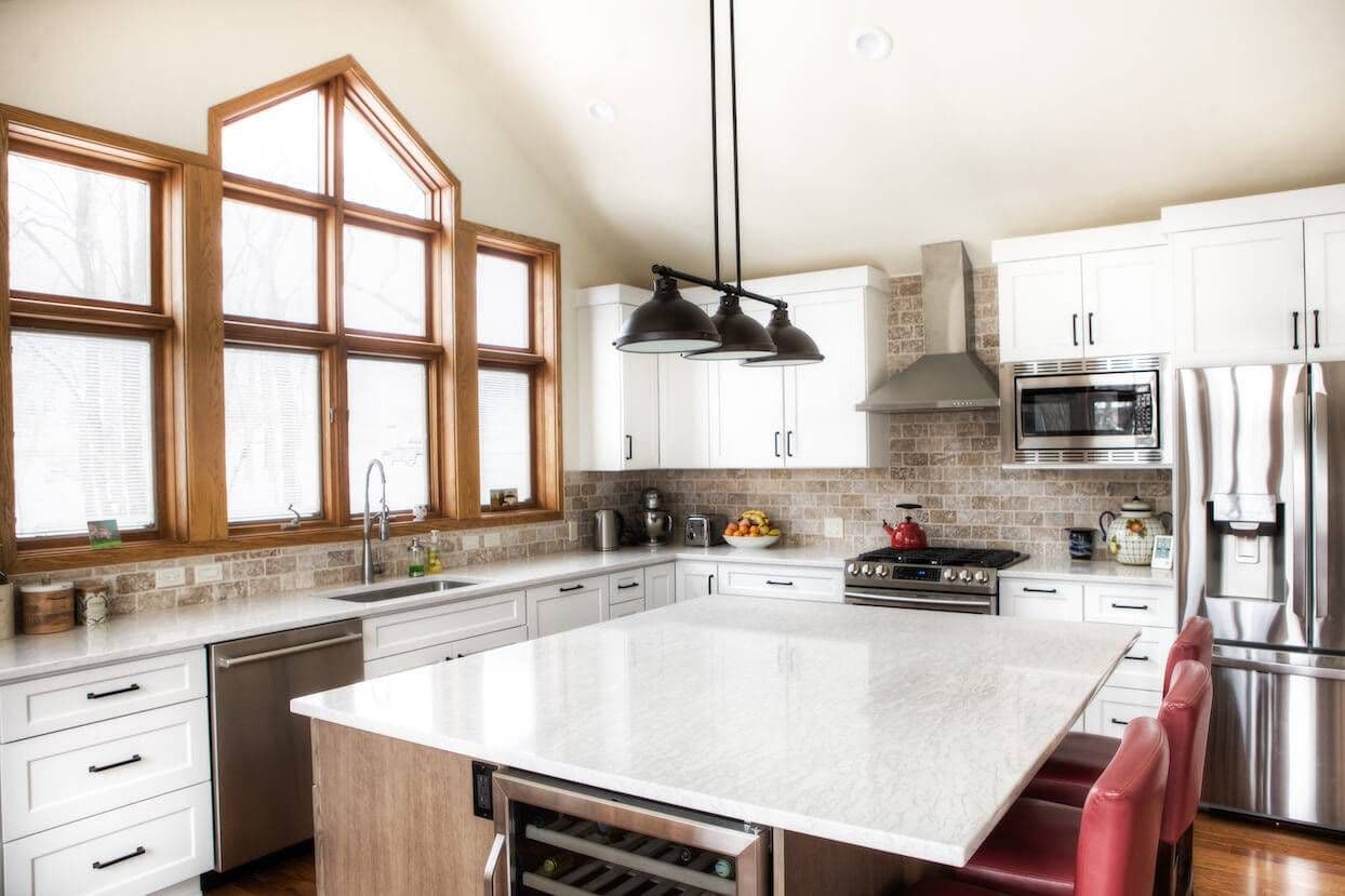 rustic kitchen with red bar stools