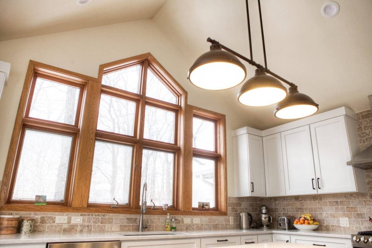 kitchen pendant lights and large windows over the sink