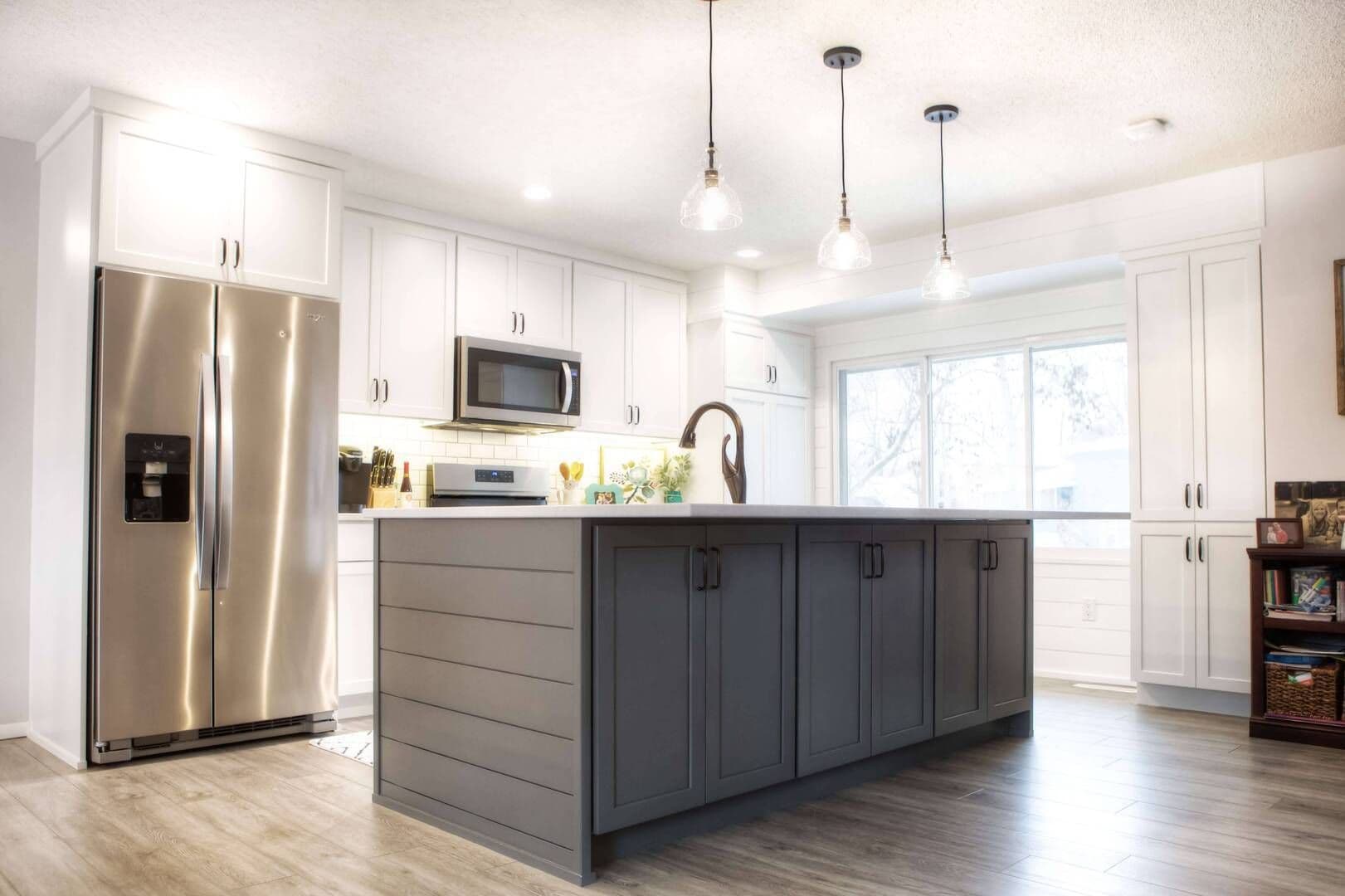 remodeled kitchen featuring a large island and windows letting in natural light