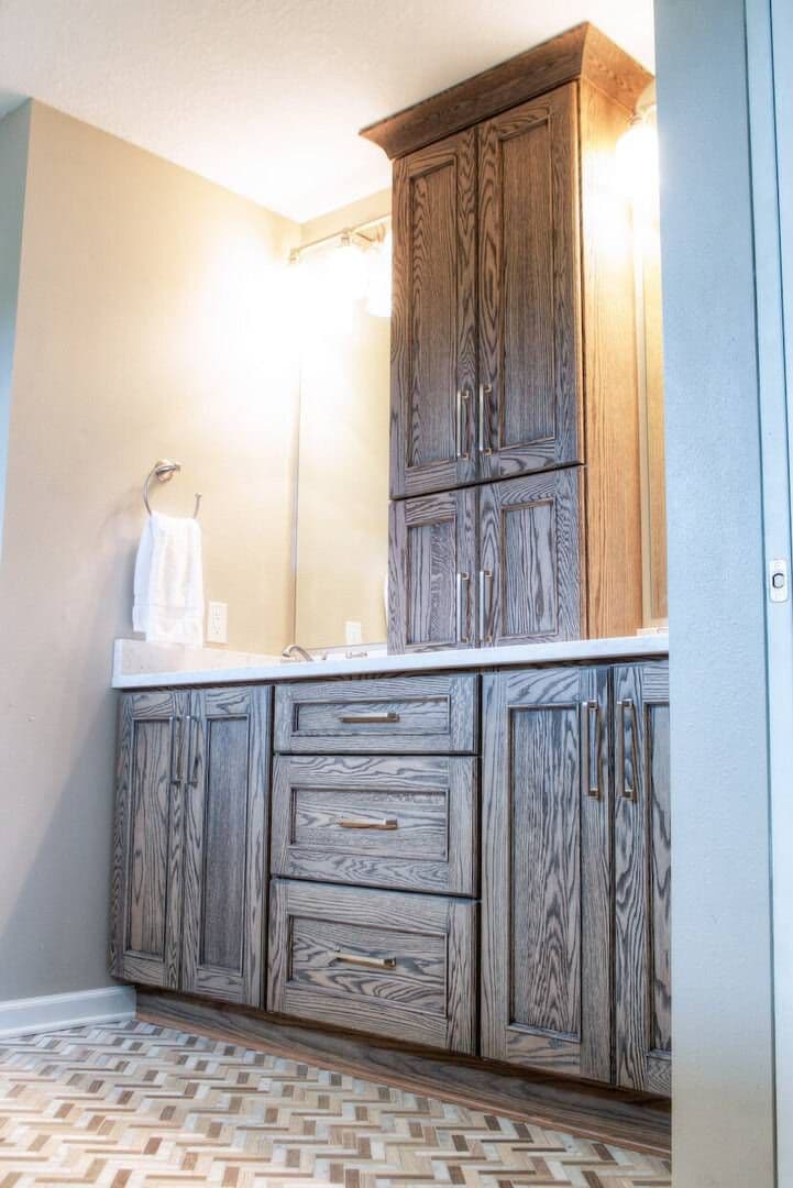 wooden vanity in new bathroom with lights on